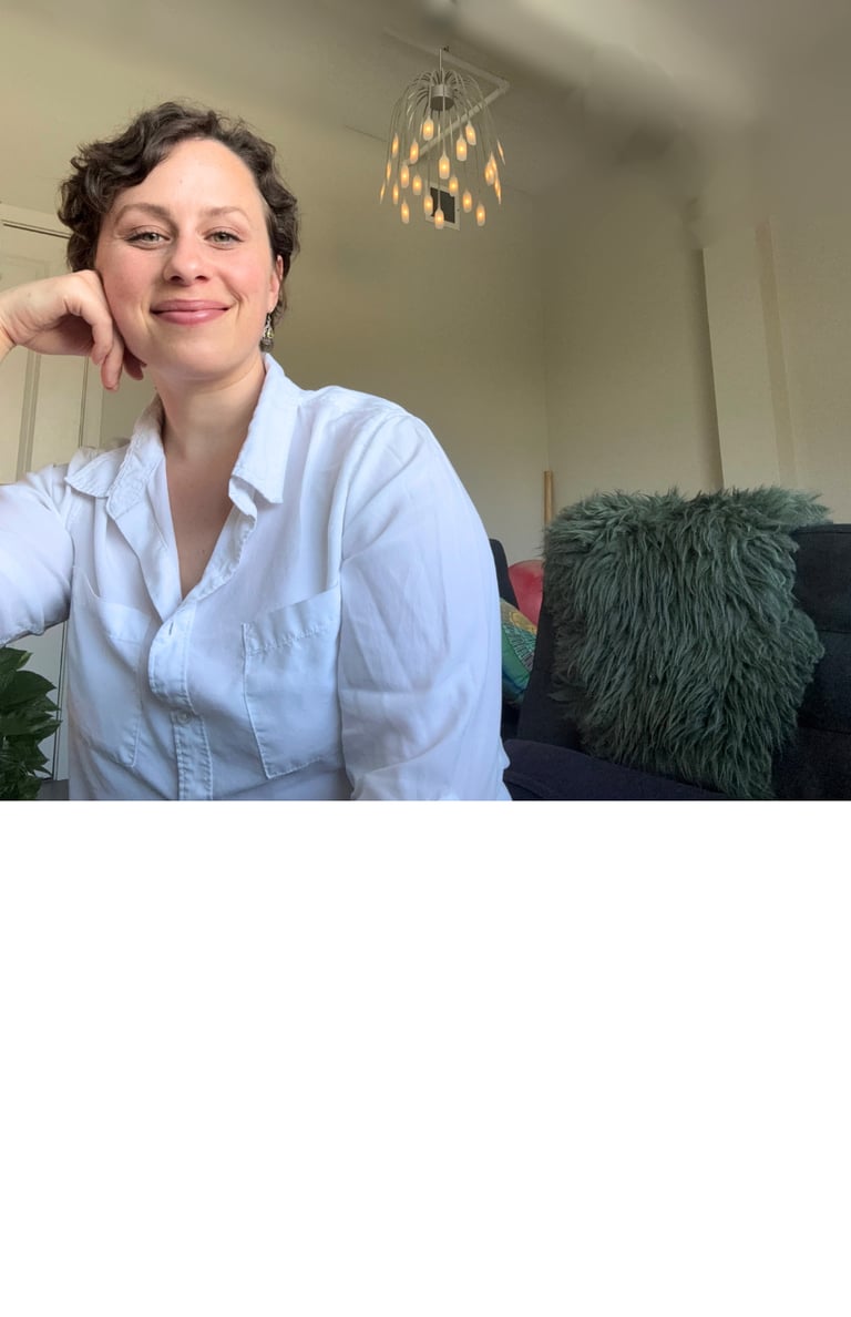 a woman in a white shirt and a black couch