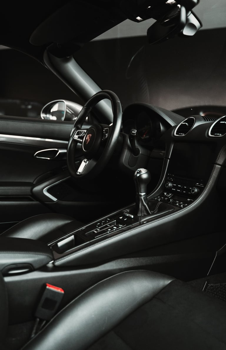 a car dashboard with a steering wheel and dashboard controls