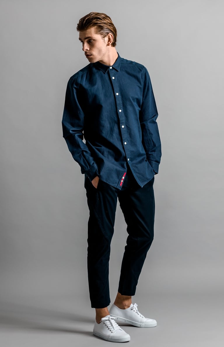 Fashion Photography - a man in a blue shirt and white sneakers