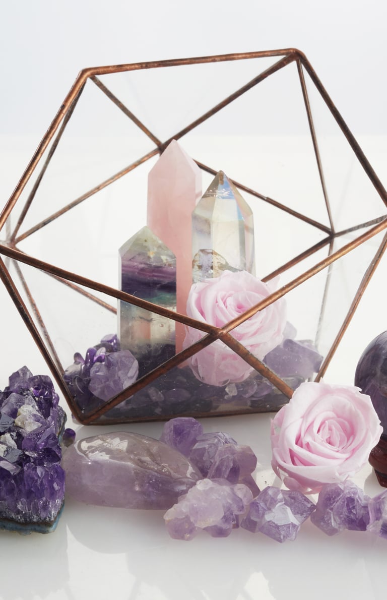 a glass box with a candle and a candle holder