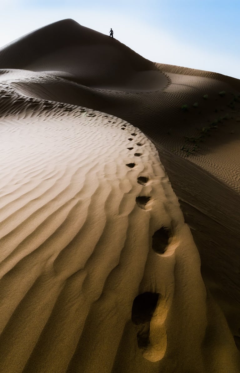 a person walking on a sand dune dune dune dune dune dune dune dune dune dune