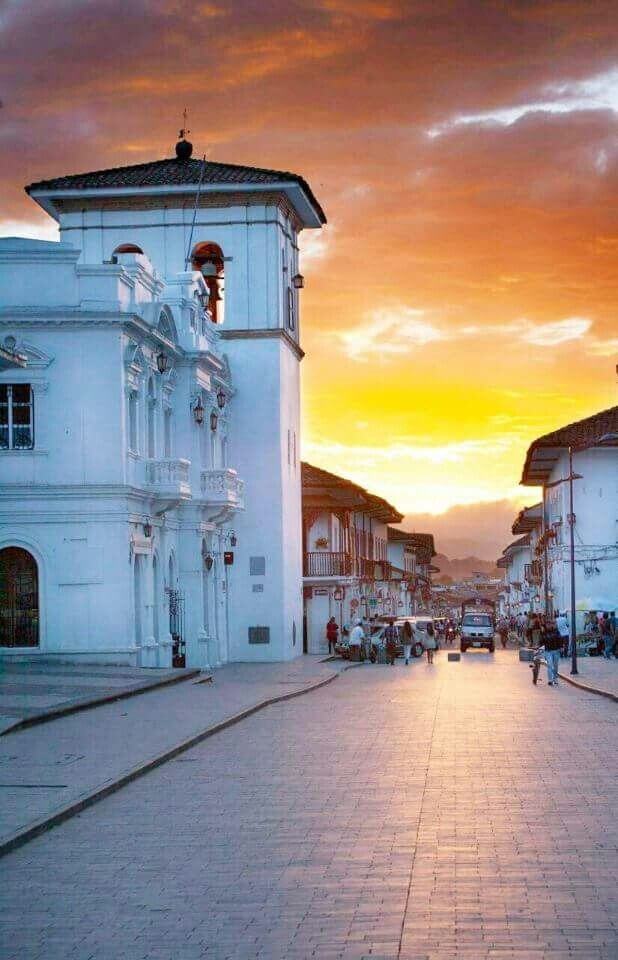 Sunset over white colonial architecture and cobblestone streets in Popayán, Colombia.