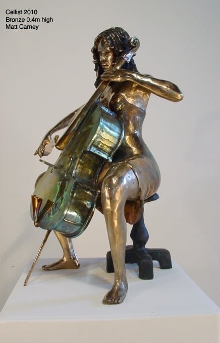 a statue of a woman playing the cello