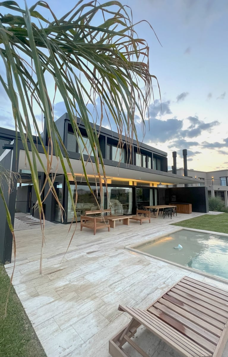 a large house with a pool and a wooden deck