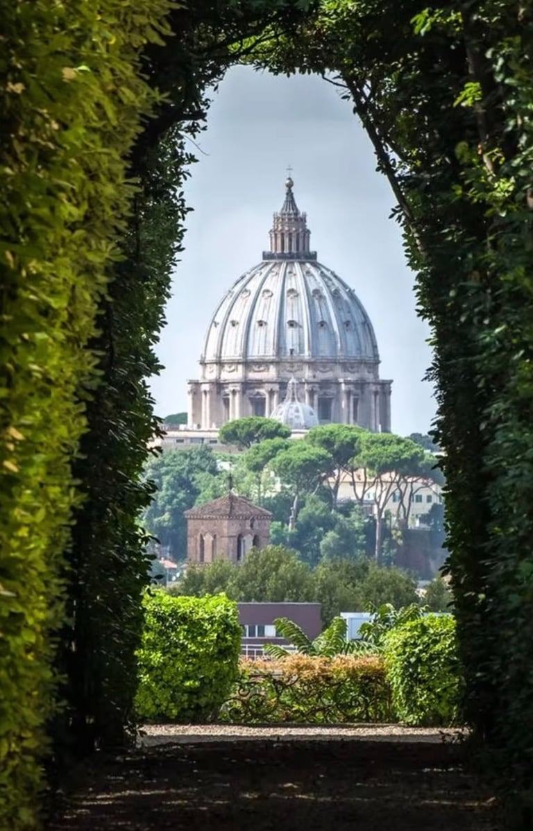 View of St. Peter's Basilica through garden arch, Rome.