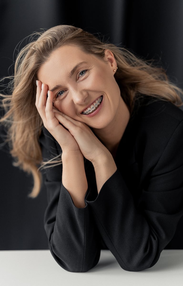 a woman with blonde hair and a black jacket