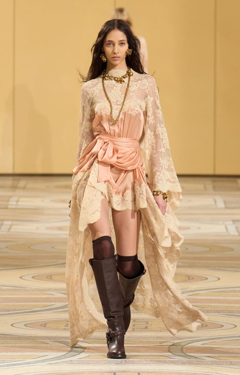 a woman in a dress and boots walking down a runway Fall 2025 ready to wear zimmerman