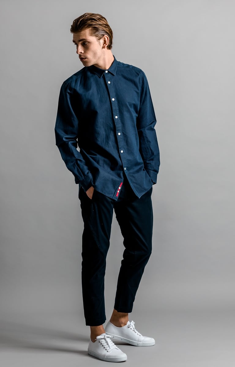 Fashion Photography - a man in a blue shirt and white sneakers