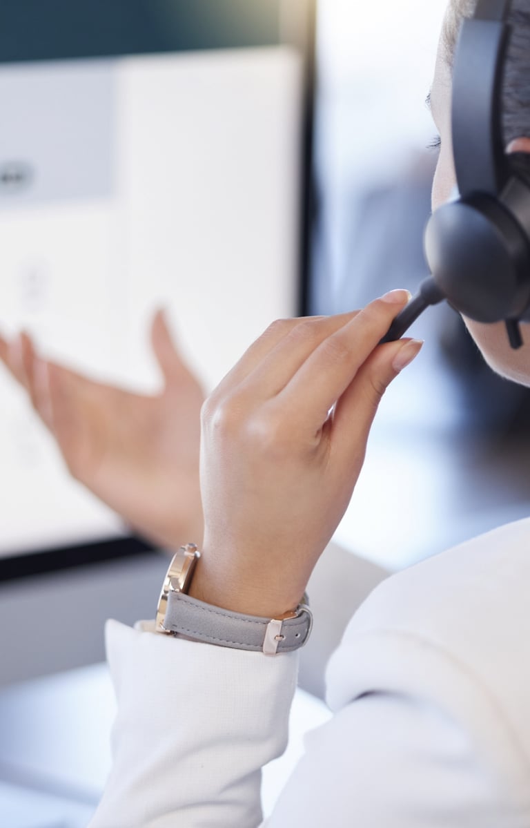 a woman in a white shirt and headphones is holding a headset