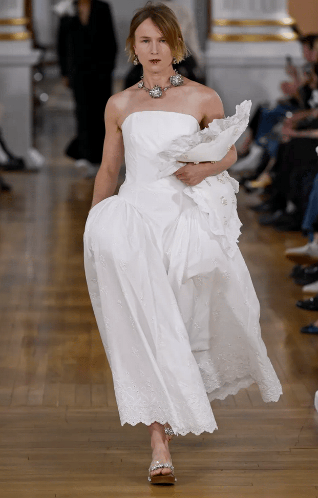 Simone Rocha model in white strapless embroidered gown on the runway at London Fashion Week 2026.