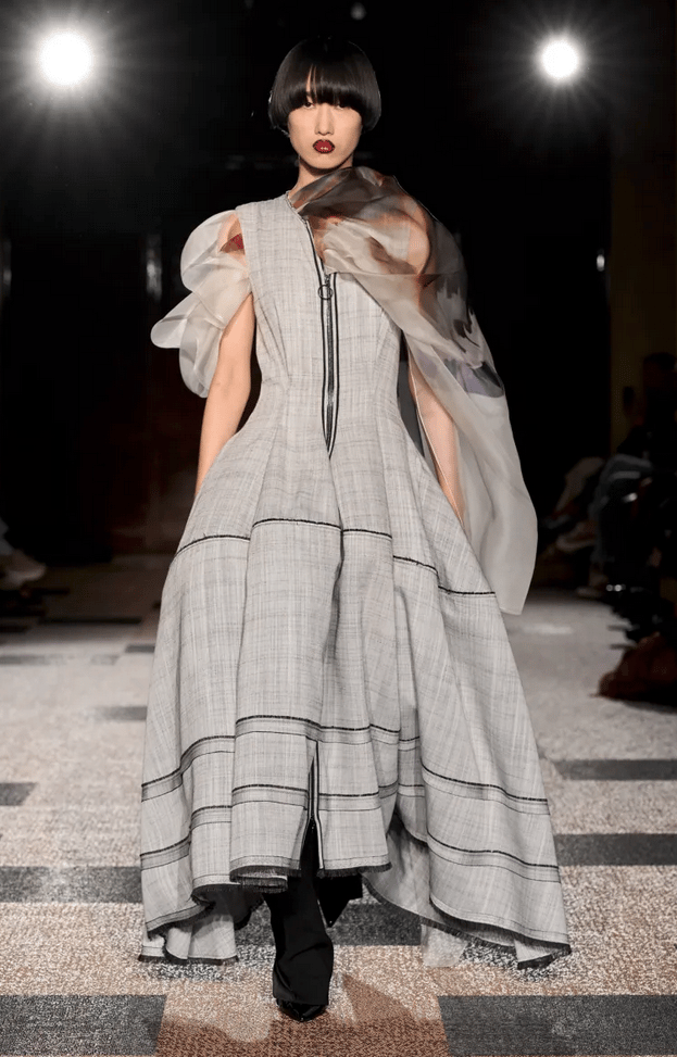 Roksanda model in grey sculptural dress with sheer scarf on the runway at London Fashion Week 2026.