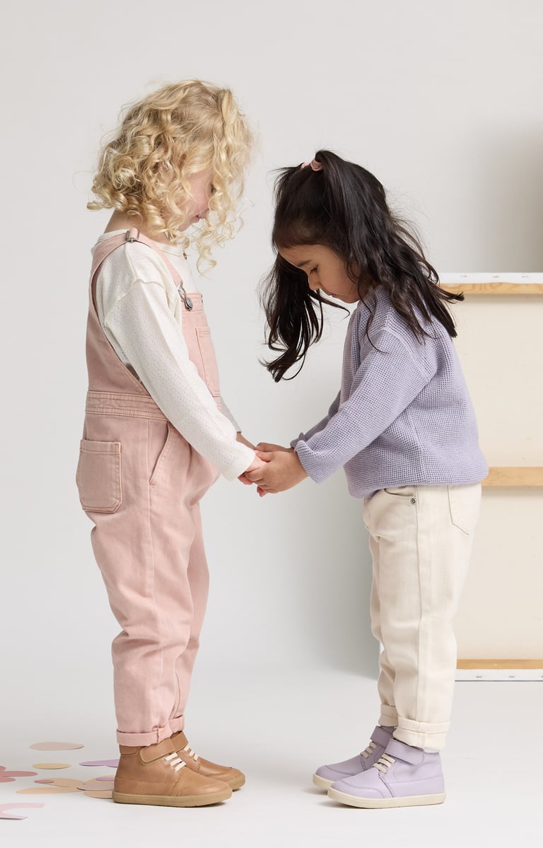 Fashion campaign photography - two young girls holding hands