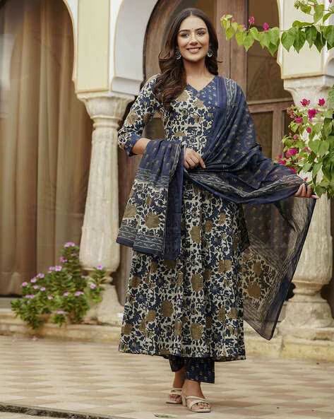Woman wearing a floral printed indigo cotton Anarkali suit with a matching dupatta and palazzo pants.