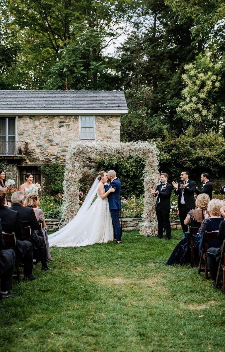 Couple kissing at alter in outdoor field
