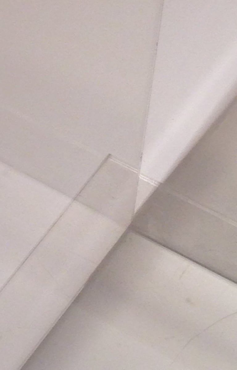 An illusion of multiple spaces created by two clear plastic sheets meeting. 