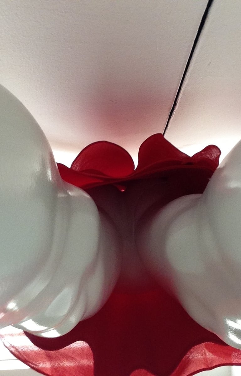 Closeup of a plastic female manekin in a red skirt.