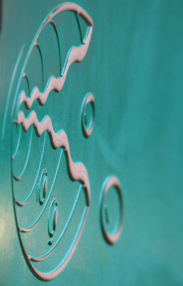 V-shaped and curved lines and circles on a green matte surface.