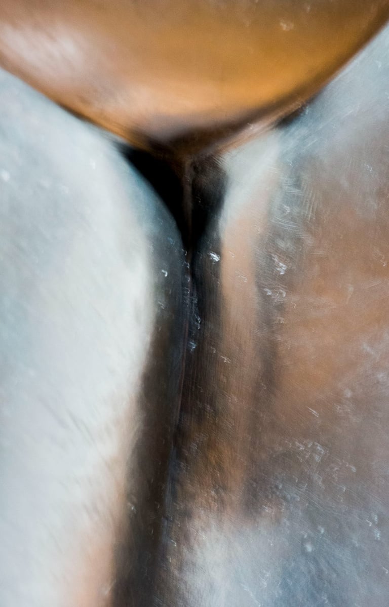 Closeup of three sliver-copper metal surfaces resembling women's closed tights and intimate spot.