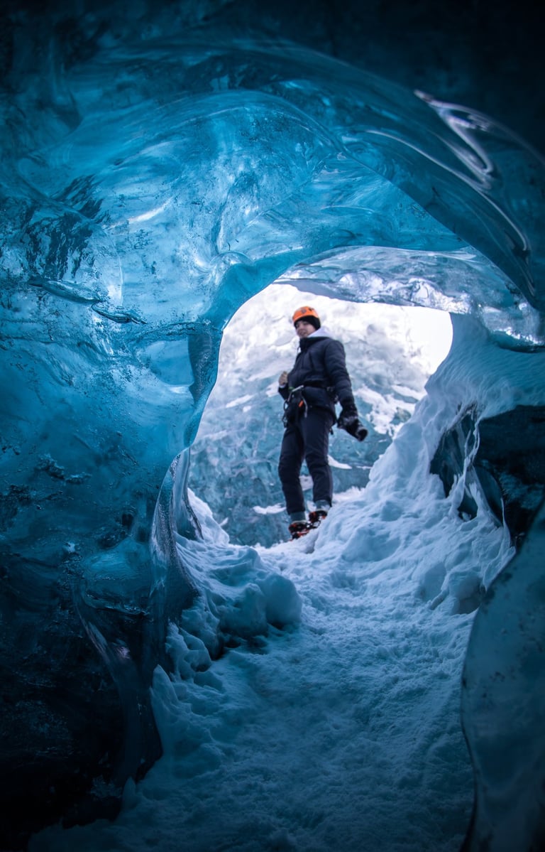 a man with a red helmet is standing in a cave