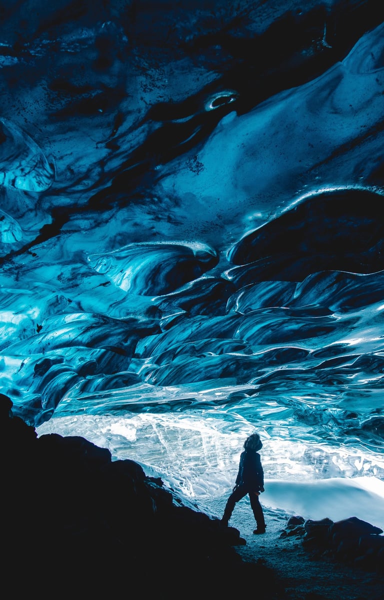 a person standing under a icy cave 