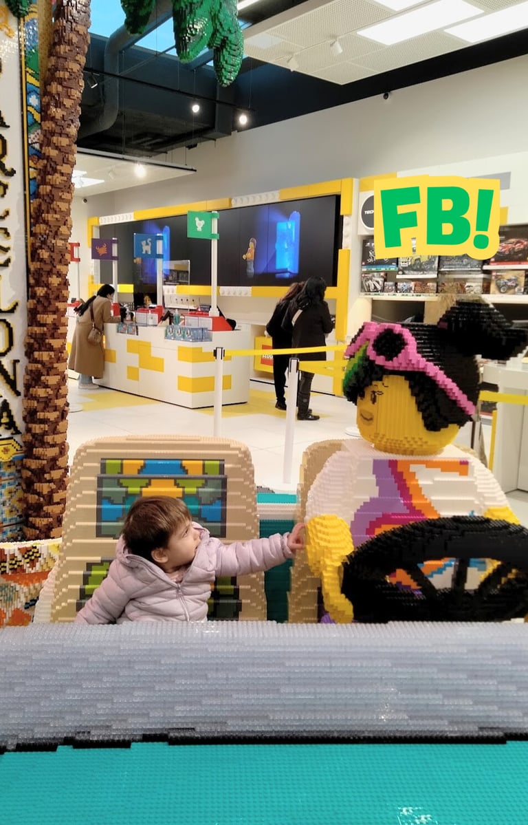 a baby in a toy car in a store