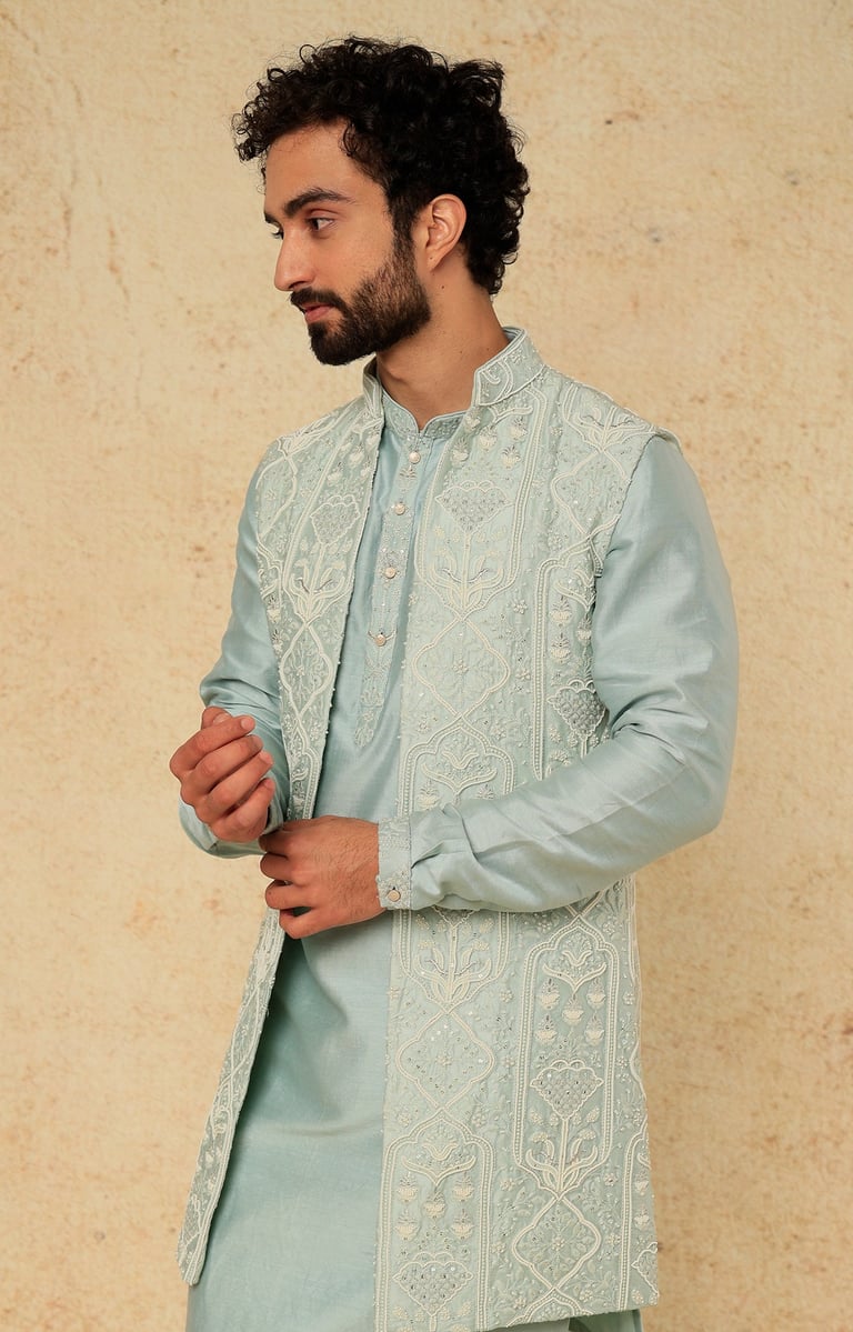 a man in a blue and white suit and a beardless man in a blue