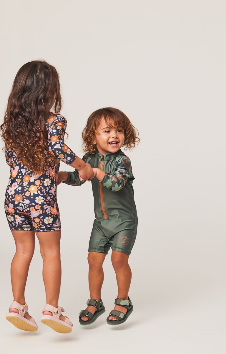 Fashion Photography - a young girl and a young boy holding hands and jumping