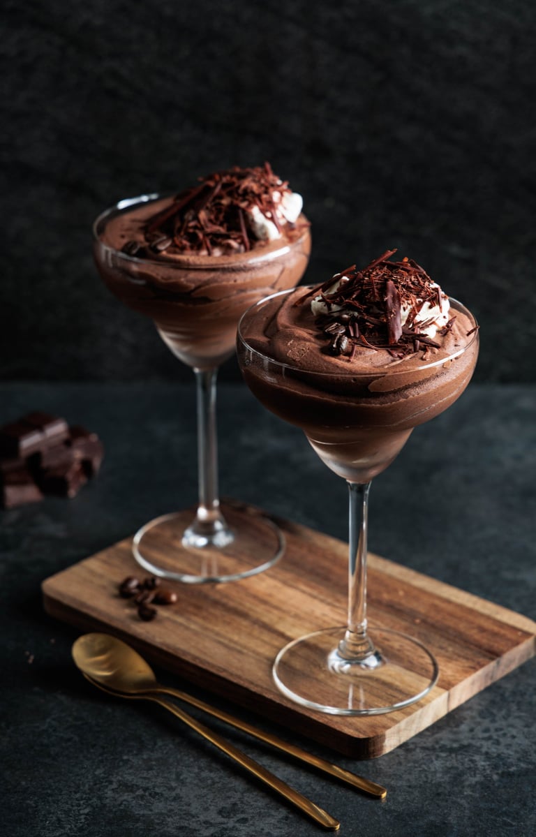 two glasses of chocolate mousse with whipped cream