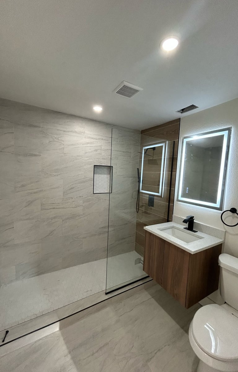 Bathroom renovation in Kissimmee with walk-in shower, ceramic tile, and modern vanity — remodel by F