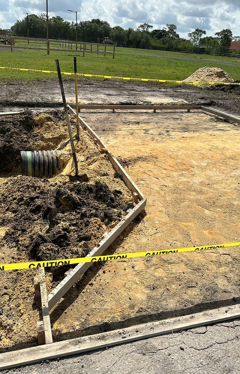 Residential driveway installation using pavers and compacted gravel base — expert exterior remodelin