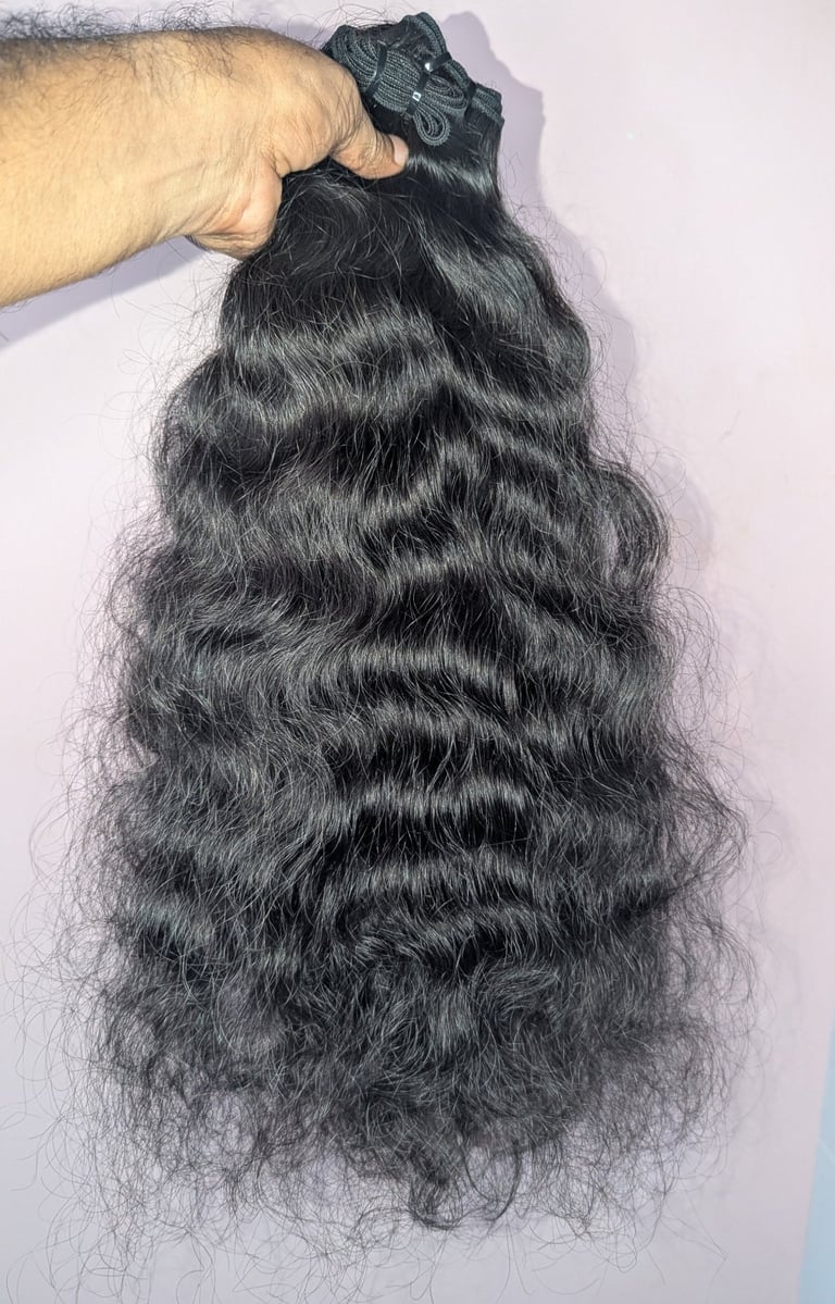 Wavy raw human hair bundles from Tanori Hair LLP prepared for wholesale export