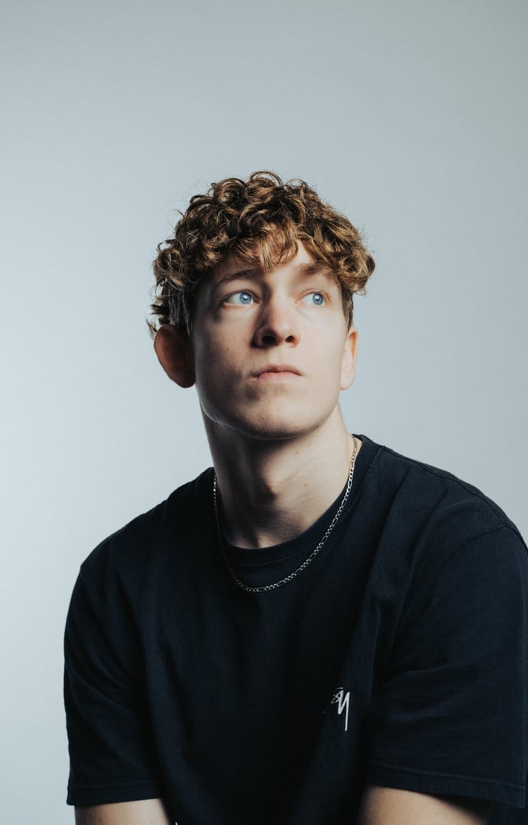portrait of a man with blue eyes and a black shirt