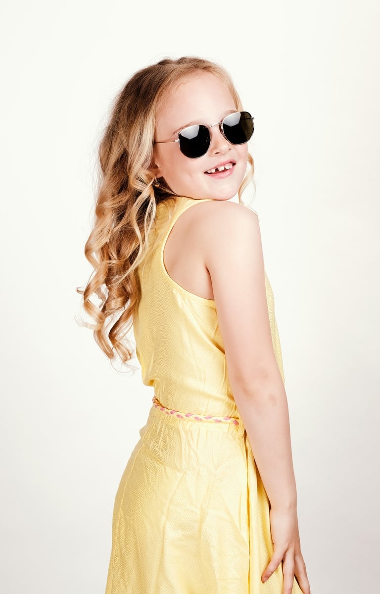 a young girl wearing sunglasses and sunglasses