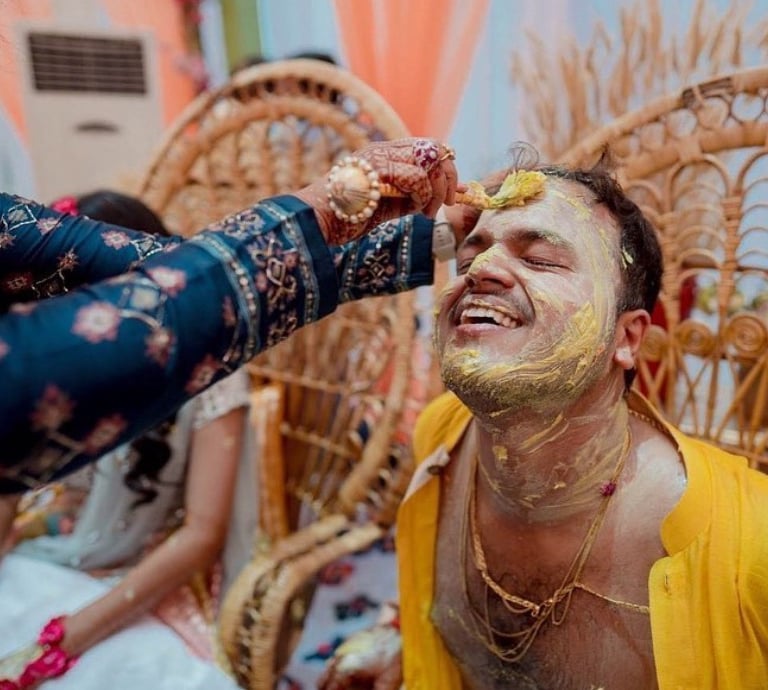 a man with a beard and a woman with a yellow face paint on his face