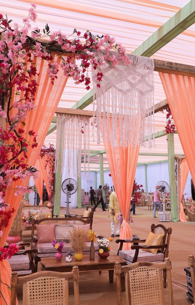 a wedding ceremony with a pink canopy tent