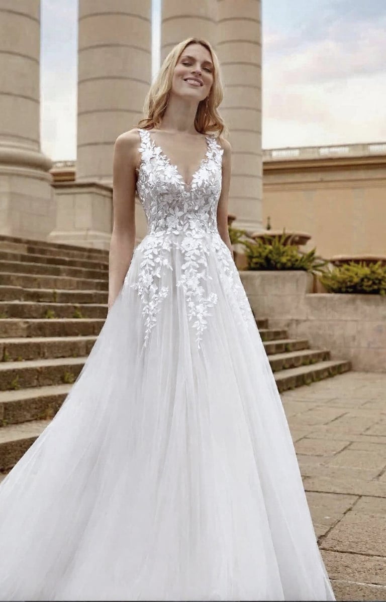 a woman in a white dress standing in front of a building