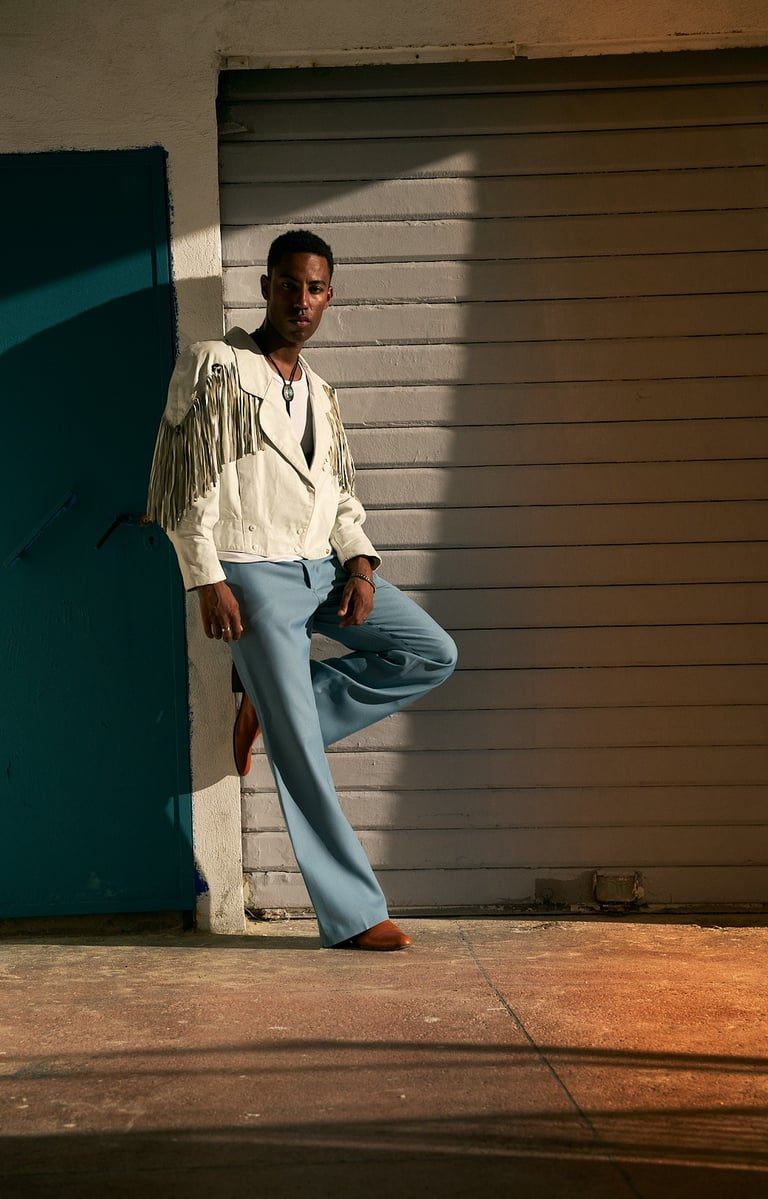 man in a stylish pose during a portrait session in Endoume, Marseille.