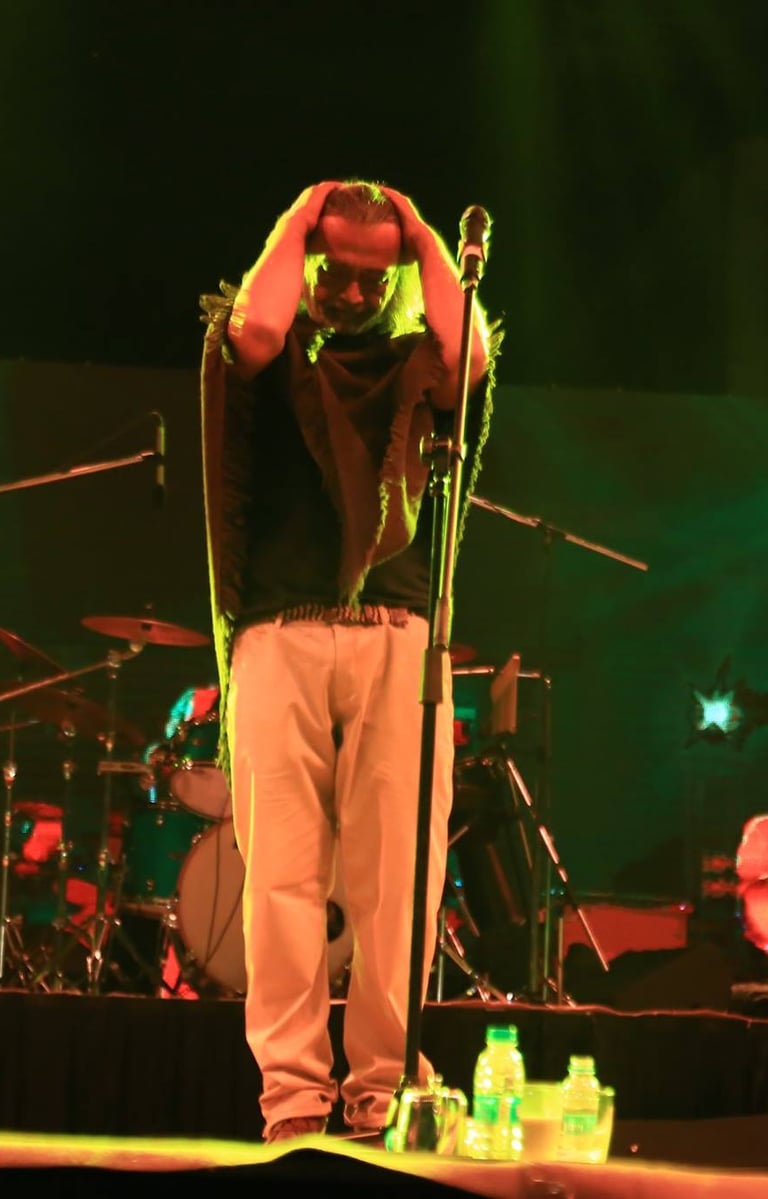 a man standing on a stage with a microphone and a microphone