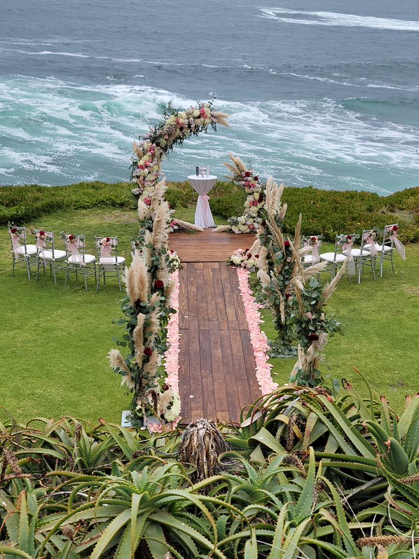 Wedding ceremony at cuvier park-the wedding bowl with custom florals and wooden aisle and platform