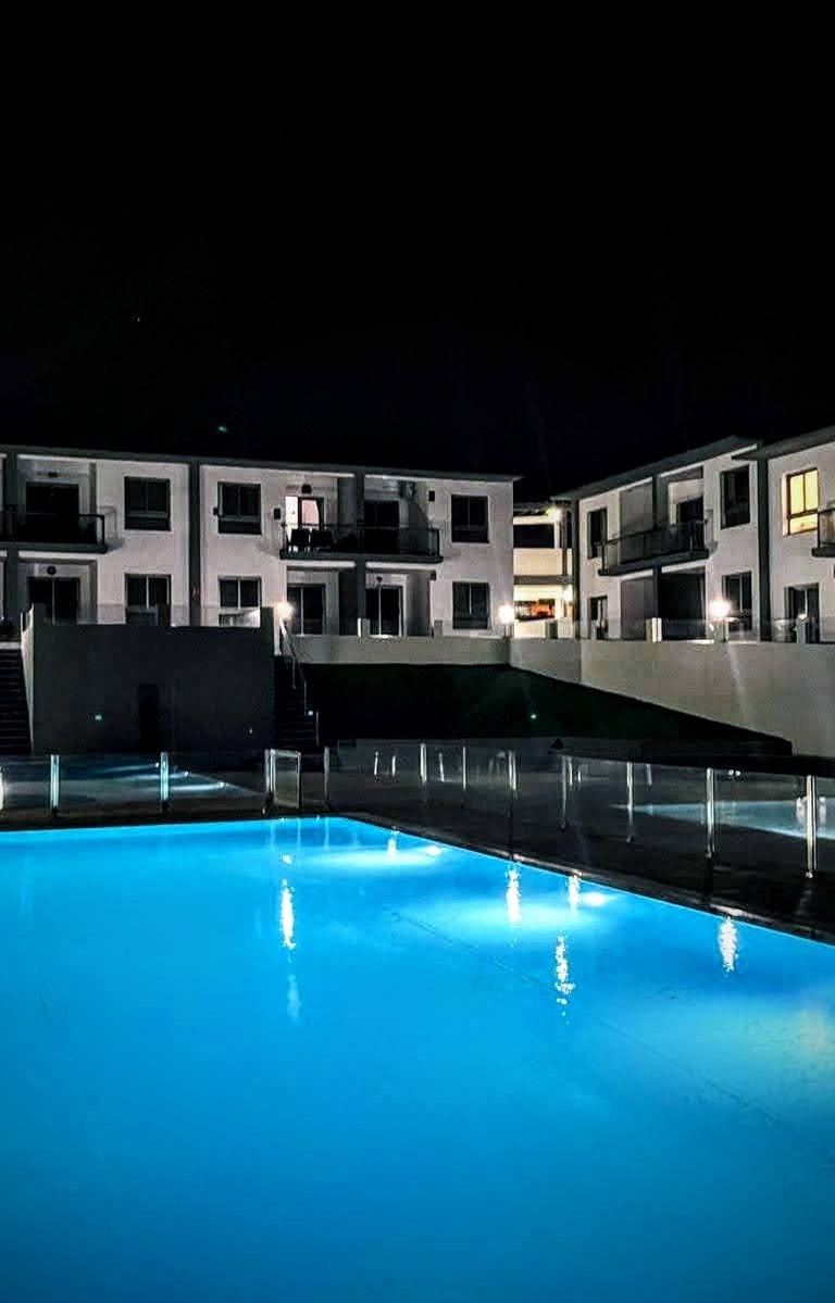 a pool with a pool and a waterfall in the background