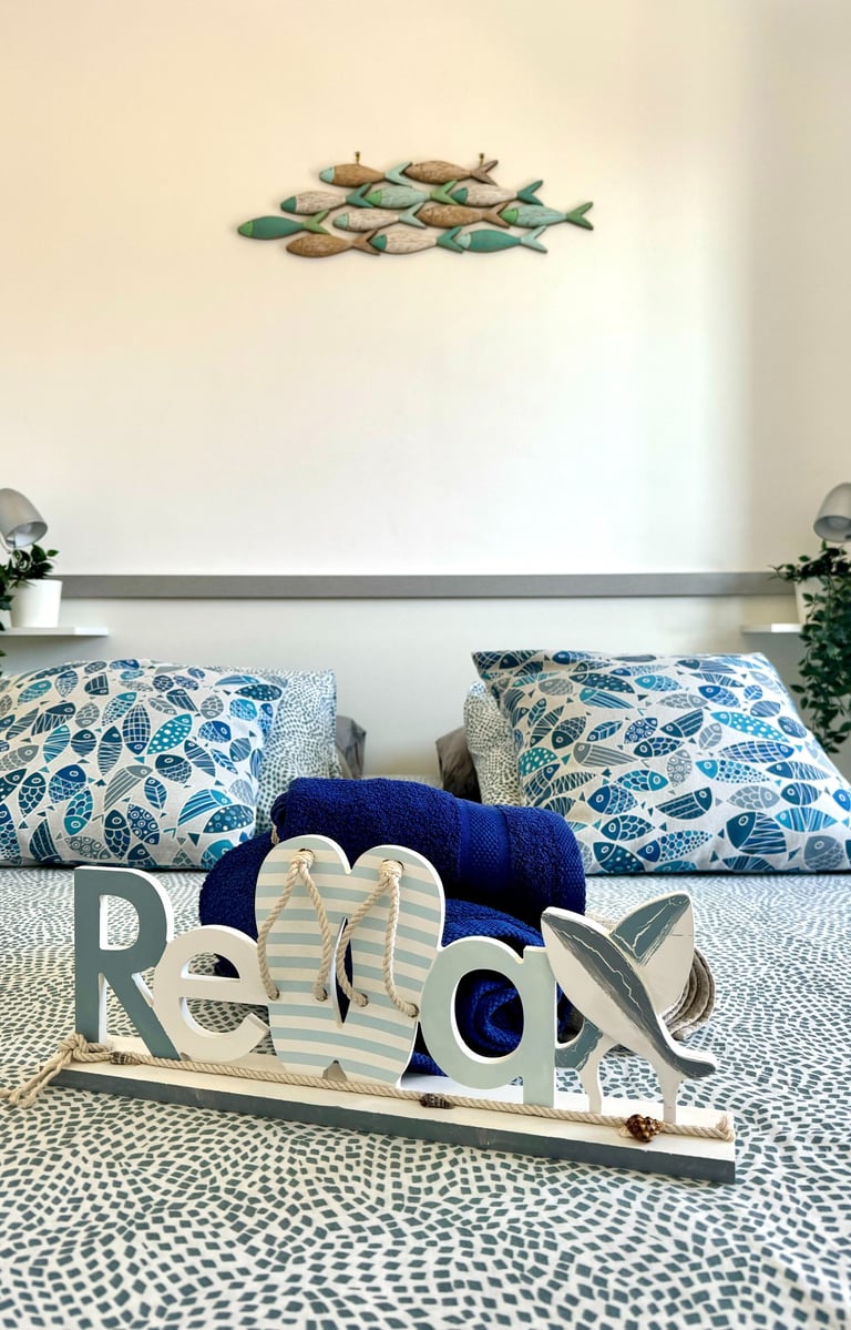 a bed with a wooden sign that says Relax