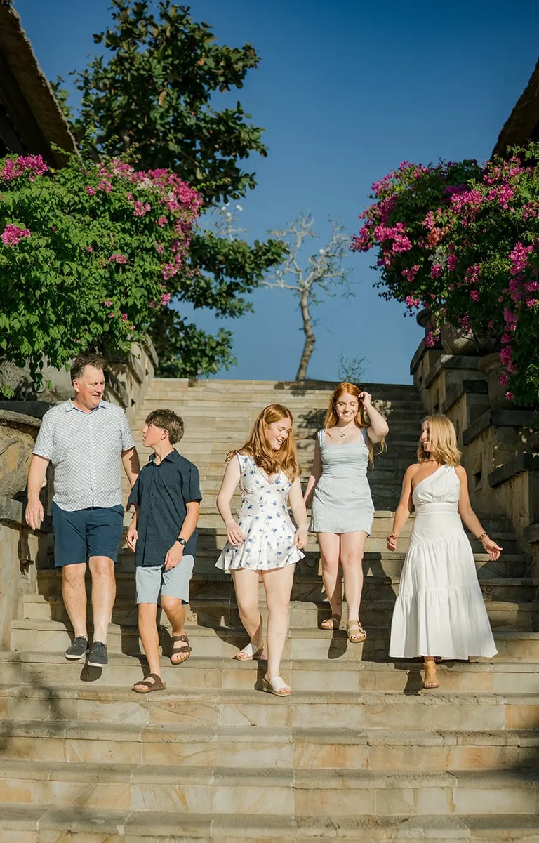 Family walking down the stone staircase during a family photography session at AYANA Resort Bali