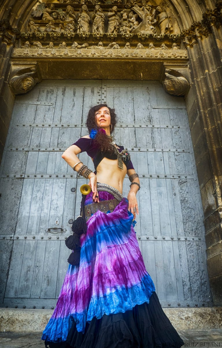 a woman in a colorful dress with a belly belt