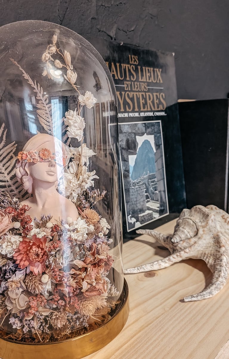 a glass dome with a lizard inside of it with an esoteric book