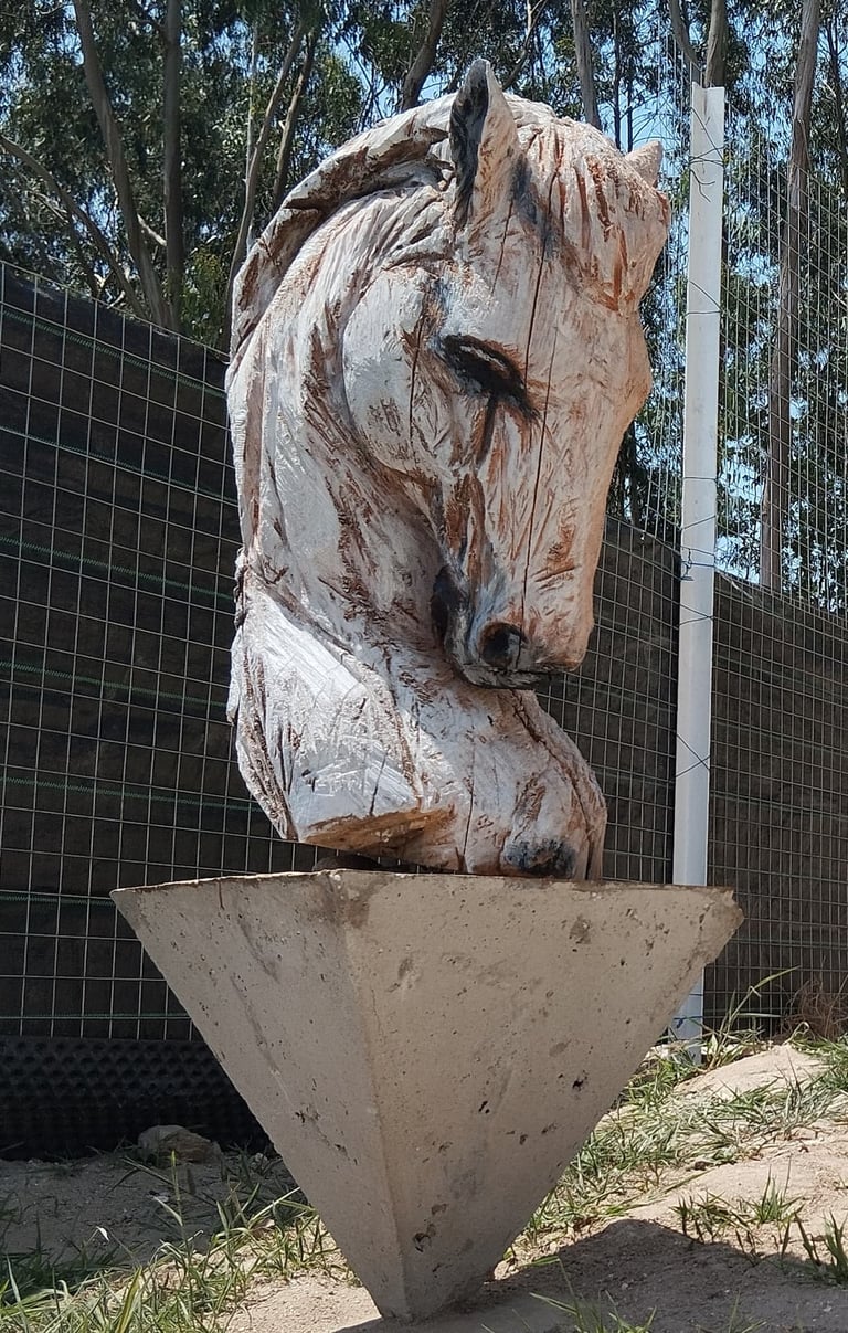 "Hand-carved wooden horse head sculpture by Axel Atelier, mounted on an inverted geometric concrete