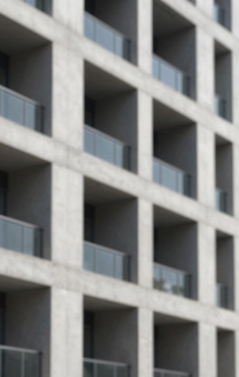 A close-up photograph of a modern concrete building facade featuring sharp shadows and a minimalist grid pattern, reflecting architectural rigor.