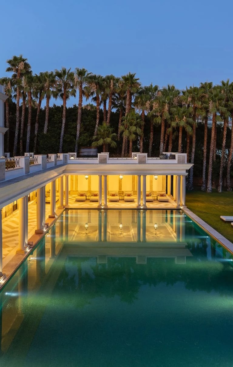 Modern villa exterior with long pool at dusk
