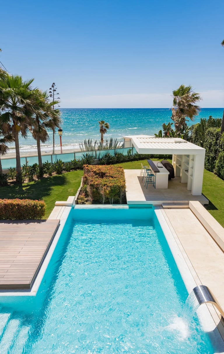 Beachfront pool and garden with outdoor bar pavilion
