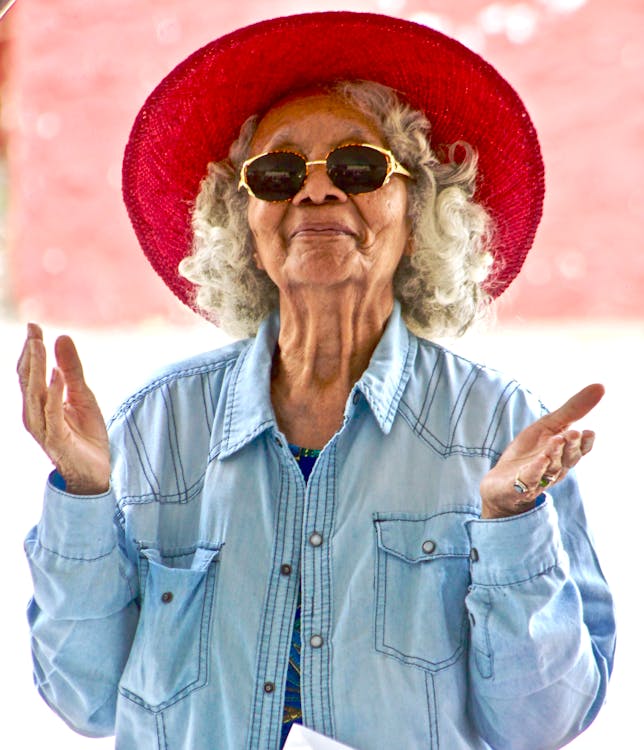a woman in a red hat and sunglasses