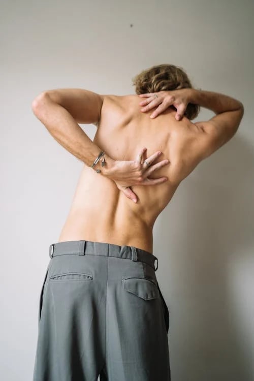 a man with a back pain and a back pain